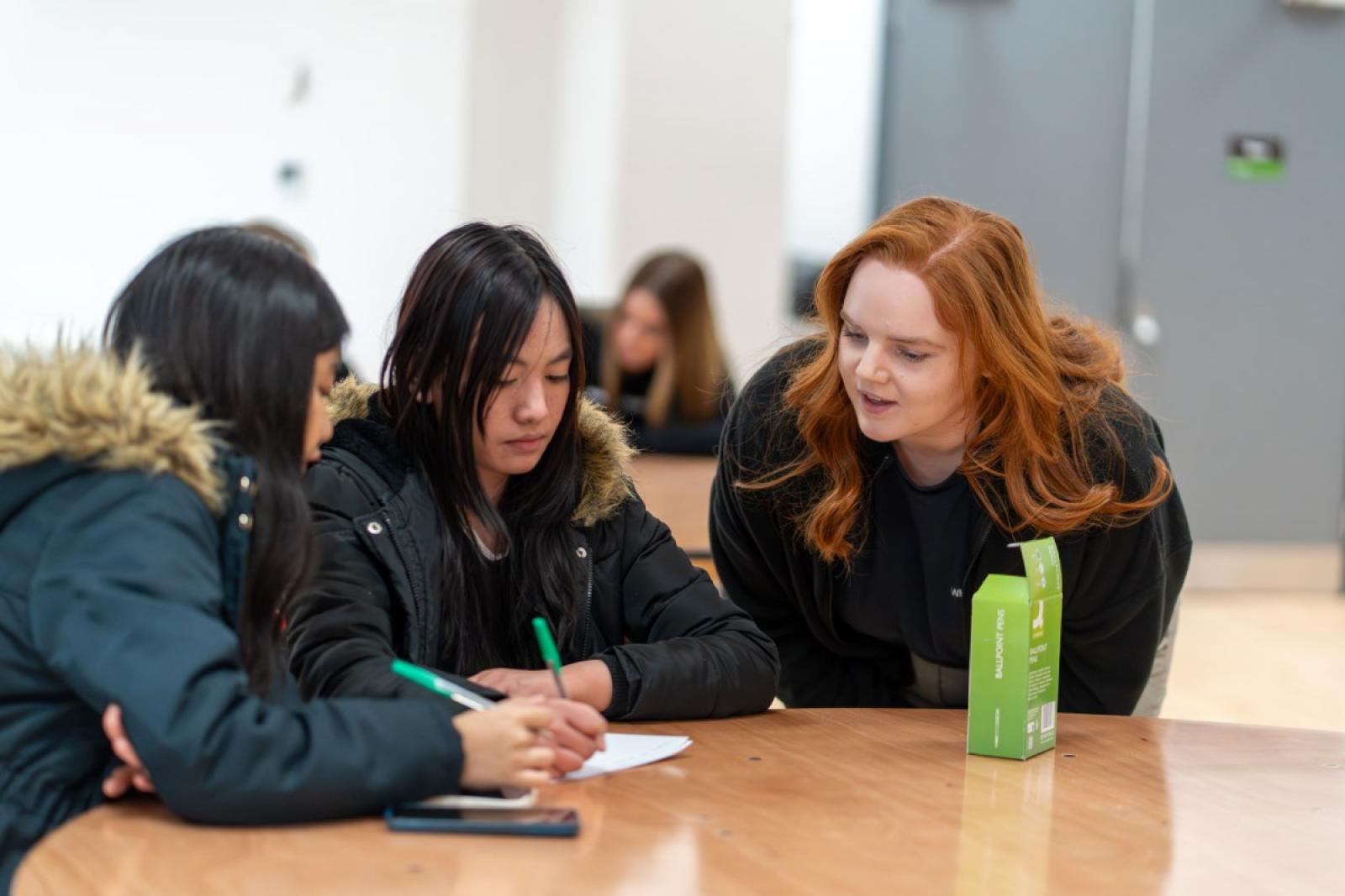 helping pupils at the table